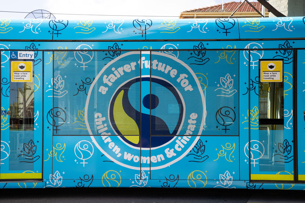 Phot: Close up image of Fairtrade's striking blue tram, with the text 'a fairer future for children, women and climate'